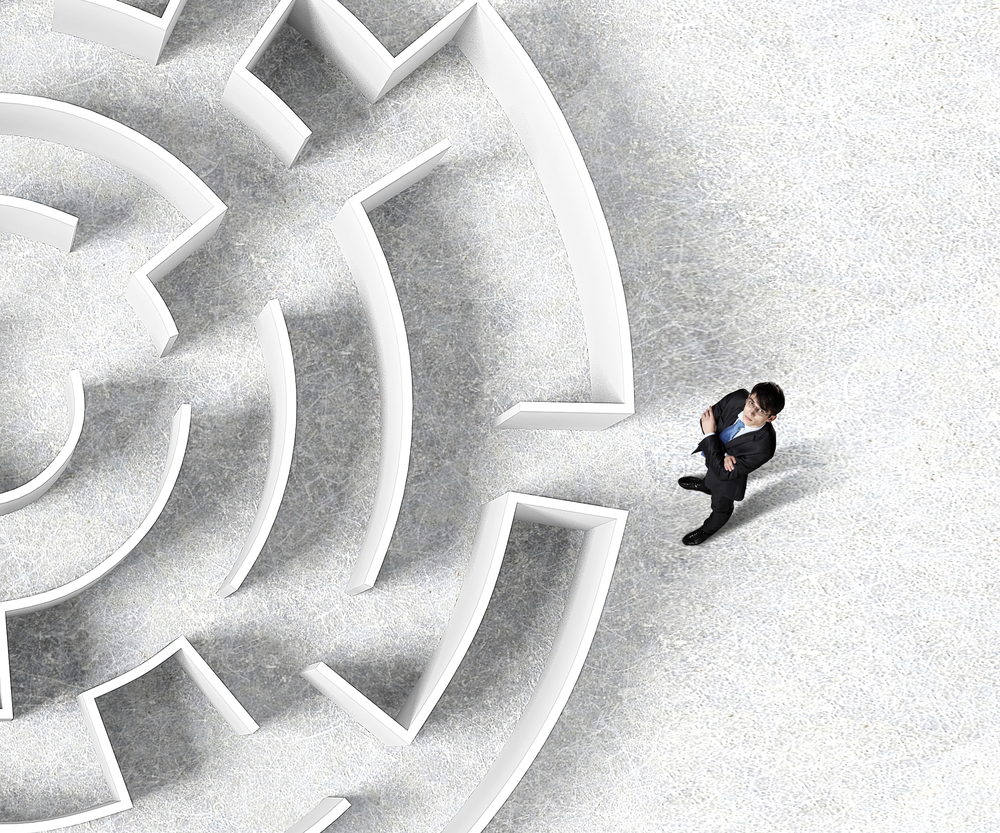 Top view of successful businessman standing near the entrance of labyrinth-1